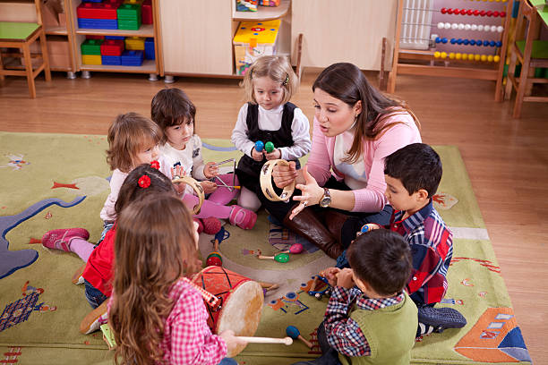 Teacher and children playing